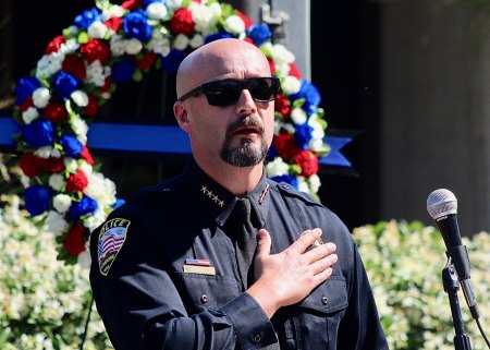 Lemoore Police Chief Mike Kendall leads the audience in the Pledge of Allegiance. 